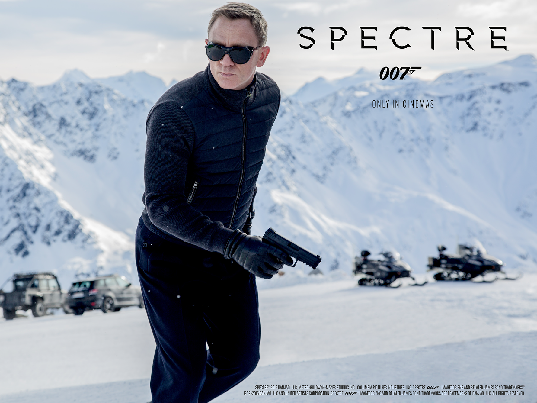 A person in a dark outfit and sunglasses holds a gun in a snowy mountain setting, with the text Spectre 007 Only in Cinemas above. Snowmobiles and a parked vehicle are in the background.