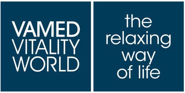 Blue background with white text reading VAMED Vitality World on the left and the relaxing way of life on the right.